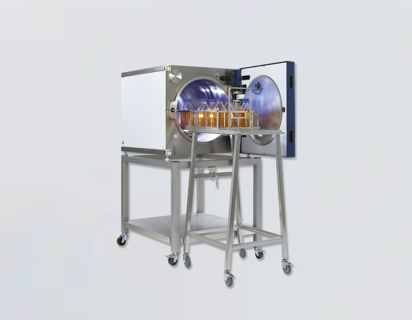Woman operating a sterilization machine. Woman operating a sterilization machine.